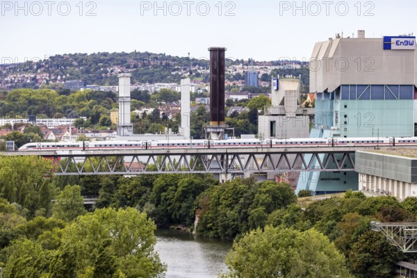 Deutsche Bahn AG ICE en route on the Schuster railway near Stuttgart. Railway viaduct over the Neckar in Stuttgart-Münster with combined heat and power plant of EnBW, Energie Baden-Württemberg. Stuttgart, Baden-Württemberg, Germany