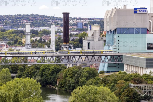 SWEG regional train travelling on the Schusterbahn, Münster viaduct over the Neckar with EnBW Energie Baden-Württemberg combined heat and power plant. Stuttgart, Baden-Württemberg, Germany