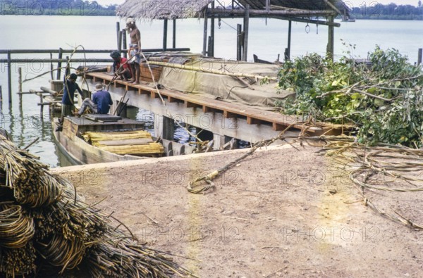 Coastal village loading boats, Singapore and Johor Bahru, Malaysia, Southeast Asia 1964