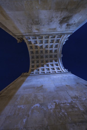View from below through a vaulted arcade with illuminated night sky, Siegestor, Munich, Germany