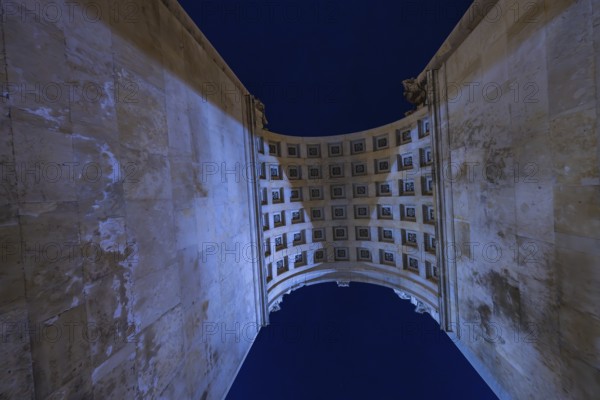 View through a high arcade into the night sky with grid structure, Siegestor, Munich, Germany