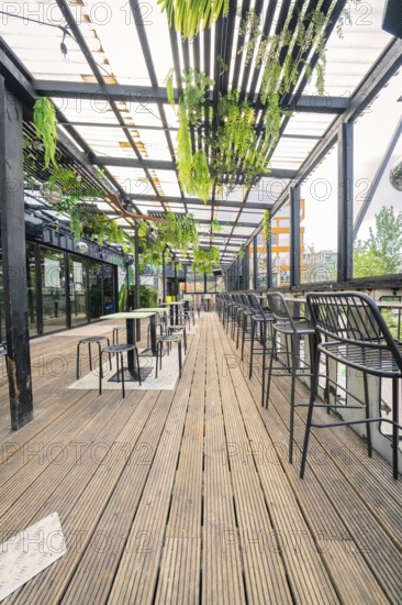 Modern terrace with wooden floor and hanging plants, industrial style, Werksviertel Munich, Munich, Germany