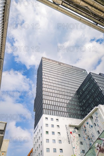 Towering modern high-rise under a blue sky with clouds, Werksviertel Munich, Munich, Germany