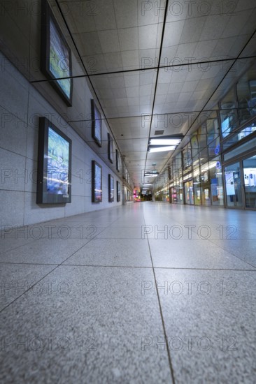Perspective of a corridor in an empty underground station with tiled floor, Münchner Freiheit, Munich, Germany