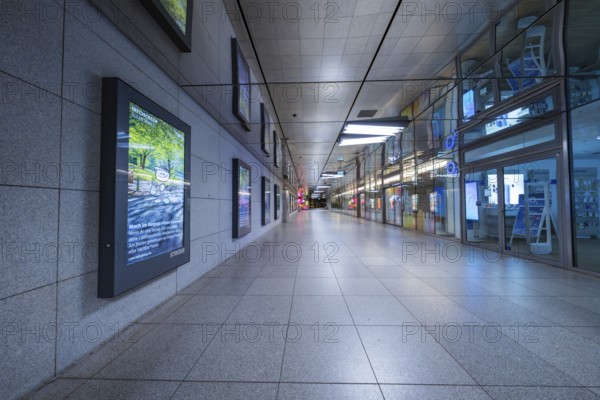 Empty corridor of a modern underground station with tiles and lighting, Münchner Freiheit, Munich, Germany