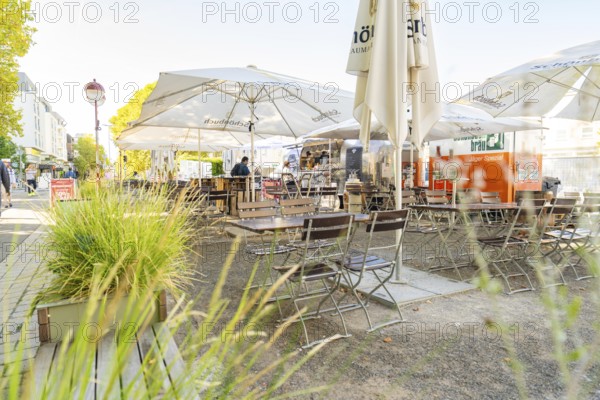 Empty tables and parasols in an urban outdoor area, Sindelfingen, Böblingen district, Germany