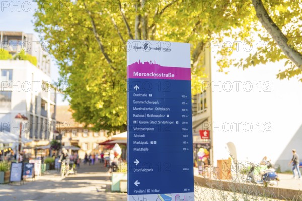 Signposts in an urban environment, destinations and distances, sunny and lively, Sindelfingen, Böblingen district, Germany