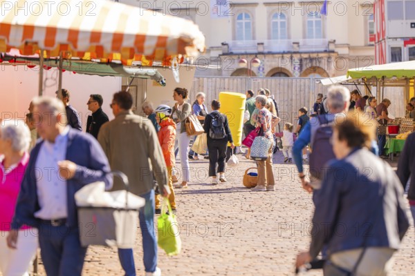 People strolling through a busy market with various stalls and colourful umbrellas, Sindelfingen, Böblingen district, Germany