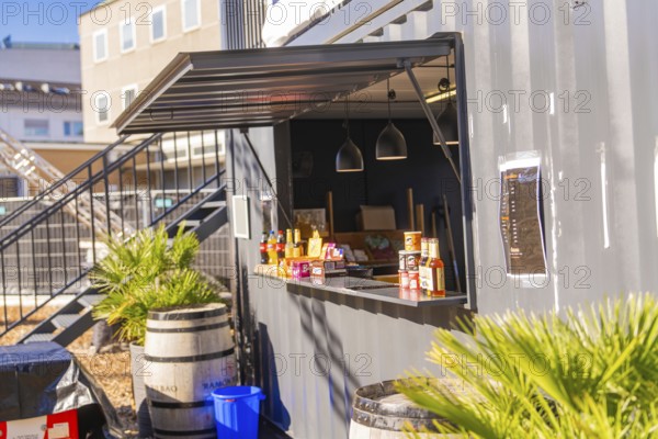 Close-up view of a snack bar in a container with barrels and plants, open-air cinema Sindelfingen, district of böblingen, Germany