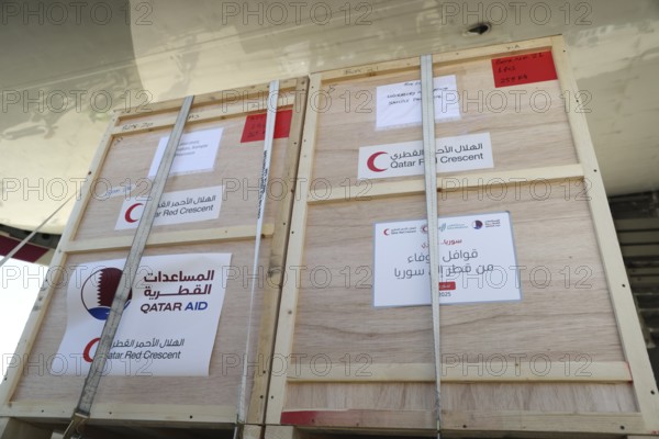 Relief workers unload boxes of medical aid provided by Qatar at Damascus International Airport, part of the humanitarian bridge supporting Syria's recovery and reconstruction after the fall of Bashar al-Assad, Damascus, Damascus, Syria