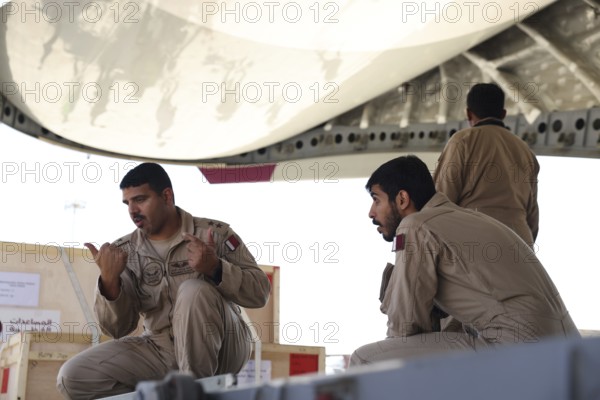Members of the Qatari Air Force unload humanitarian aid supplies from a transport aircraft at Damascus International Airport as part of Qatar's air and land relief bridge to Syria, Damascus, Damascus, Syria