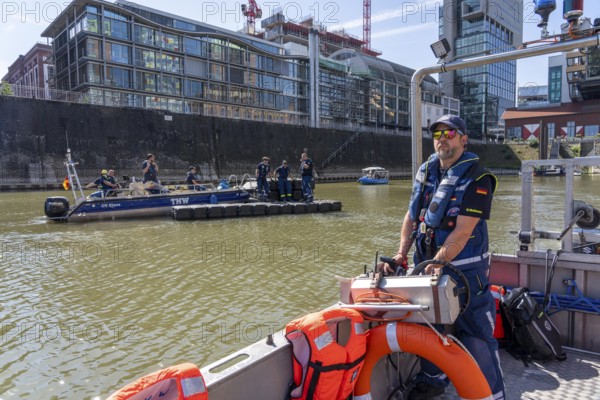 Multi-purpose boat of the THW during a training trip on the Rhine, Medienhafen in Düsseldorf, of the specialist group for water hazards, this type of boat is used to transport people and goods as a rescue boat and as a working platform, during the major exercise FÜLEX25, lasting several days, of the THW, Technisches Hilfswerk, Landesverband North Rhine-Westphalia, on 4 weekends over 3500 volunteers from the 127 North Rhine-Westphalia local associations practise many different deployment scenarios