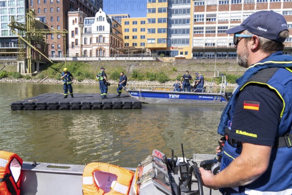 Transport of a floating platform with the jet-float system, this can be used as a work platform, jetty or bridge, water hazards specialist group, multi-purpose boat accompanied, in Düsseldorf, at the major exercise FÜLEX25, lasting several days, of the THW, Federal Agency for Technical Relief, North Rhine-Westphalia, over 3500 volunteers from the 127 North Rhine-Westphalia local associations practise many different deployment scenarios over 4 weekends