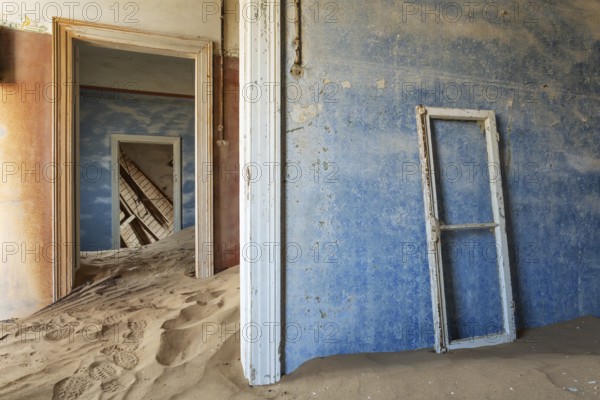 At Kolmanskop, the abandoned ghost town of the diamond days of the early 1900 and of German origin. Inside the restricted Diamond Area east of the coastal town of Lüderitz. Namib Desert, Namibia