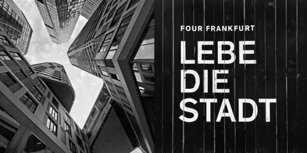 Frog's-eye view of skyscrapers in the banking district and construction fence with the inscription Lebe die Stadt, Four Frankfurt, Frankfurt am Main, Hesse, Germany