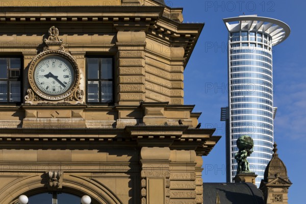 Side front of the main railway station with Atlas carrying the globe on his shoulders in front of the DZ Bank tower block, Frankfurt am Main, Hesse, Germany
