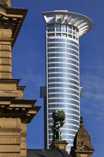 Side front of the main railway station with Atlas carrying the globe on his shoulders in front of the DZ Bank tower block, Frankfurt am Main, Hesse, Germany
