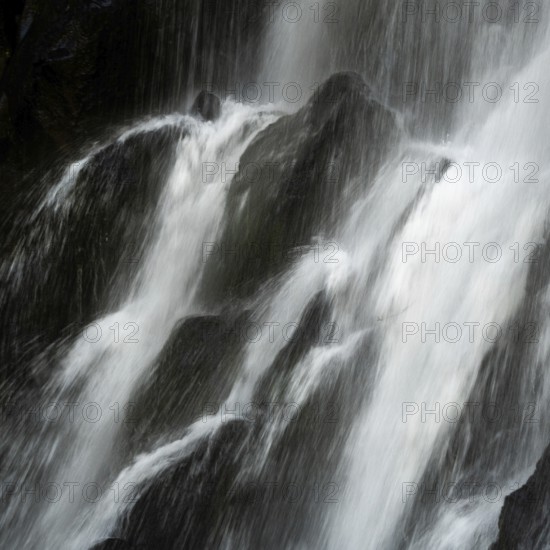 Vaucoux waterfall cascades gracefully over dark rocks, surrounded by lush greenery, Auvergne Volcanoes Regional Park, Puy de Dome., Auvergne-Rhone-Alpes, France