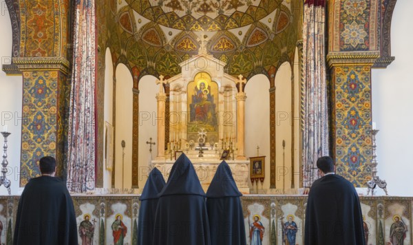 Many monks stand in front of an elaborately decorated altar with bright ornaments, Inside the historic, most important Armenian Orthodox cathedral, UNESCO World Heritage Site, Echmiadzin, Ejmiacin, Vagharshapat, Vagarshapat, Vagarshapat, Valaršapat, Vagharshapat, Armavir province, Armenia