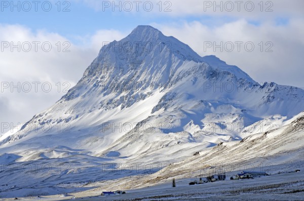 Snowy mountain under blue sky with winter landscape in the foreground, North Iceland, Iceland