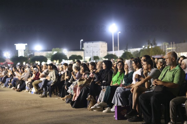 Audience members enjoy a musical performance during the Damascus International Fair in Damascus, Syria, attended by local citizens and international guests, Damascus, Damascus, Syria