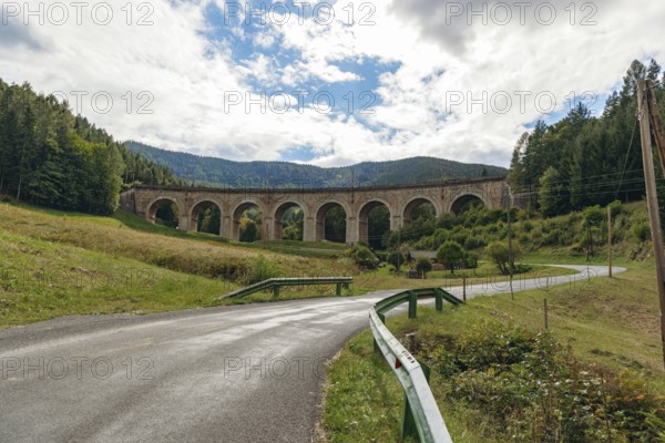 Adlitzgraben Viaduct, cloudy sky and green hills, Semmering Railway, Semmering, Lower Austria, Austria