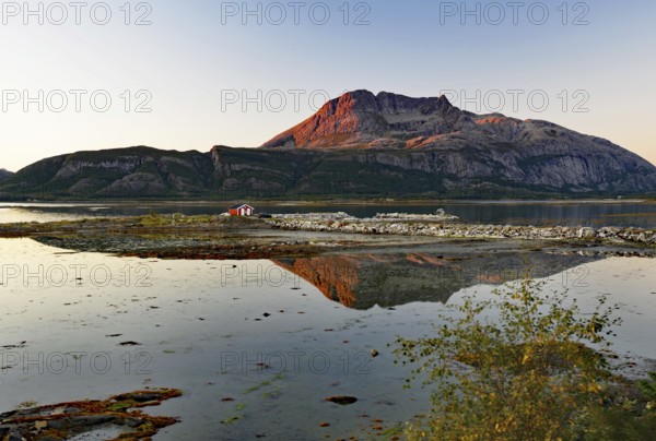 Fjord landscape with lake during sunset, reflected in calm water, Offersöy, Kystriksveien, Nordland, Norway