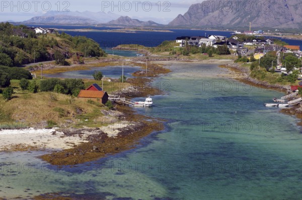Coastal landscape with islands, clear waters and mountains in the background, Brönnöysund, Nordland, Norway
