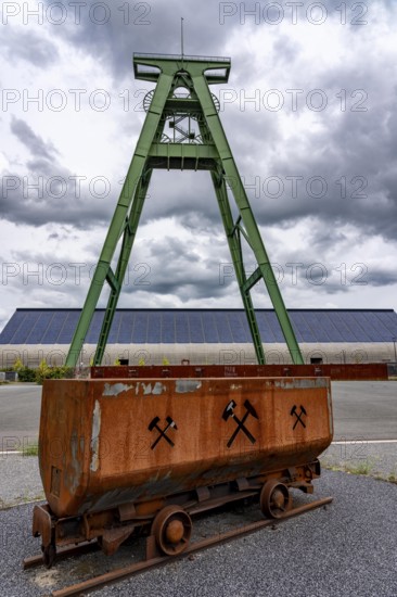 The former Lohberg coal mine in Dinslaken, today a leisure, work and residential quarter, Kreativquartier Lohberg, pithead frame of shaft 2, behind the coal mixing hall with 11500 square metre solar roof, output of 1, 813 KW peak power, freshly renovated, North Rhine-Westphalia, Germany