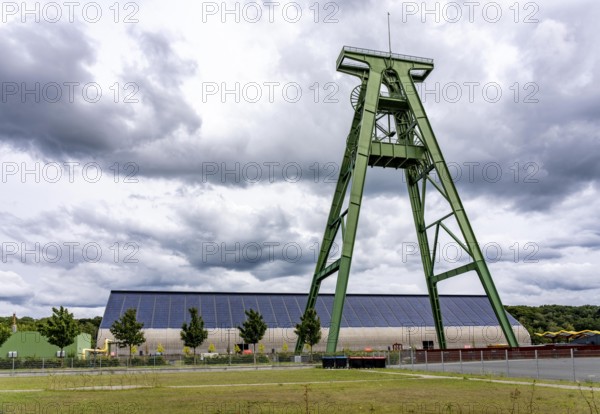 The former Lohberg coal mine in Dinslaken, today a leisure, work and residential quarter, Kreativquartier Lohberg, pithead frame of shaft 2, behind the coal mixing hall with 11500 square metre solar roof, output of 1, 813 KW peak power, freshly renovated, North Rhine-Westphalia, Germany