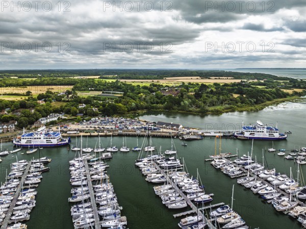 Wight Light car ferry to Isle of Wight on Lymington River and marina from drone, Lymington, New Forest, Hampshire, England, United Kingdom