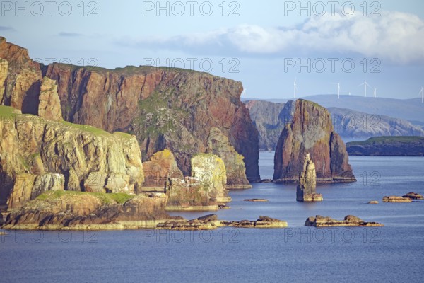 Imposing cliffs tower over the calm sea under a cloudy sky, Eshaness, Shetland Islands, Scotland, United Kingdom