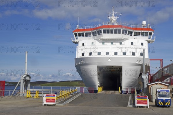 A large ferry is in the harbour ready for embarkation under a clear sky, Lerwick, Shetland Islands, Scotland, United Kingdom