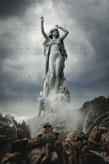 Undine Fountain with dramatic sky in the spa garden Baden, Lower Austria, Austria