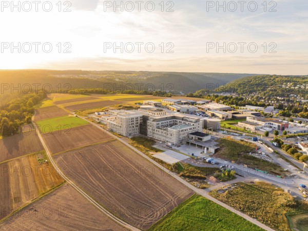 Extensive landscape with a modern building surrounded by fields and hills, new hospital building, Calw health campus, Black Forest, Germany