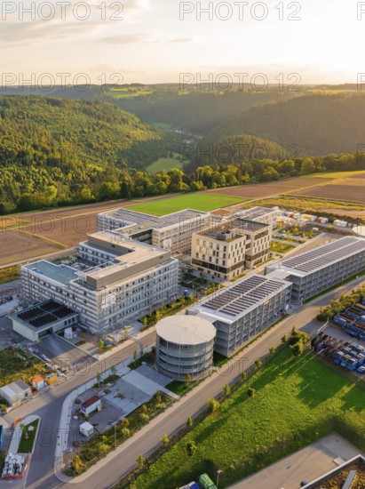 Building complex with modern structures surrounded by fields and trees, new hospital building, Calw health campus, Black Forest, Germany
