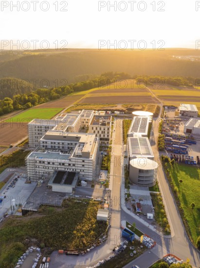 Compact aerial view of a modern building complex at sunset, new hospital building, Calw health campus, Black Forest, Germany
