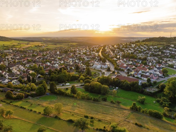 Spacious residential area with open fields and forests at sunset, small town of Perle Calw, Black Forest, Germany