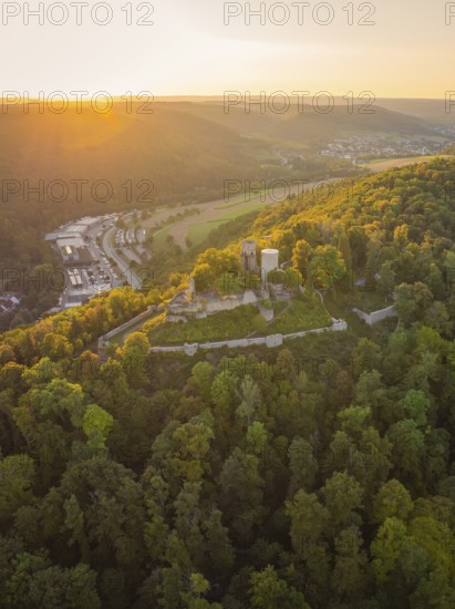Castle ruin on a wooded hill at sunset, surrounded by nature, small town Perle Nagold, Black Forest, Germany