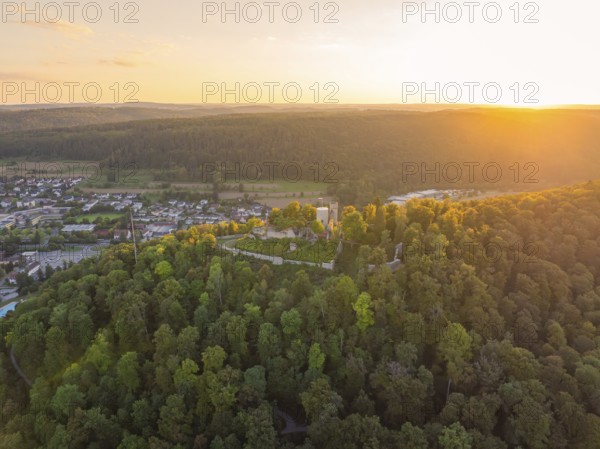 Photo panorama of a castle in dense forests at sunset with a wide view over the landscape, small town Perle Nagold, Black Forest, Germany