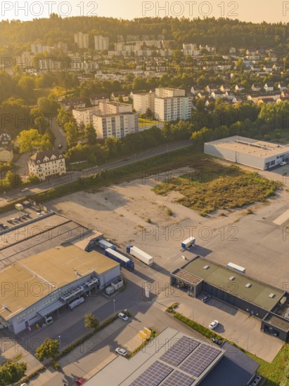 Industrial and residential area at dusk with surrounding nature and urban development, small town of Perle Nagold, Black Forest, Germany