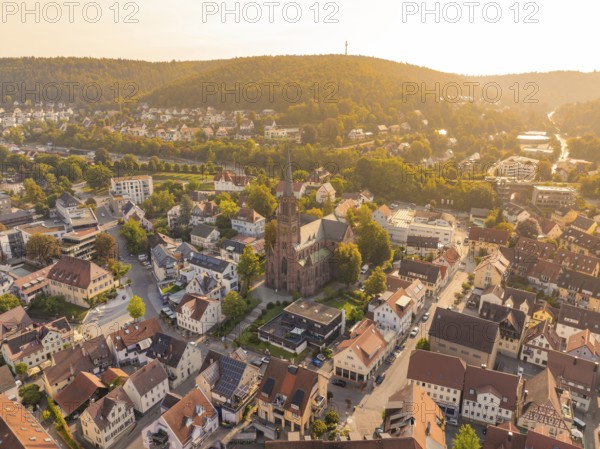 Panoramic view over the roofs of a town with a central church, surrounded by green hills, small town pearl Nagold, Black Forest, Germany