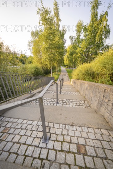 Stone staircase with metal railings, flanked by lush greenery, small town of Perle Nagold, Black Forest, Germany