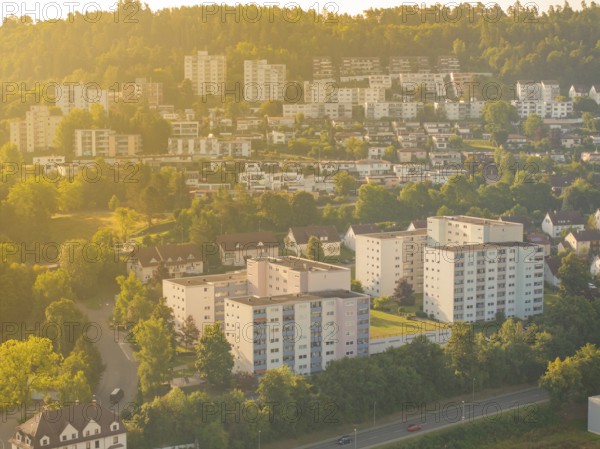Housing estate in a green, hilly area under warm sunlight, small town of Perle Nagold, Black Forest, Germany