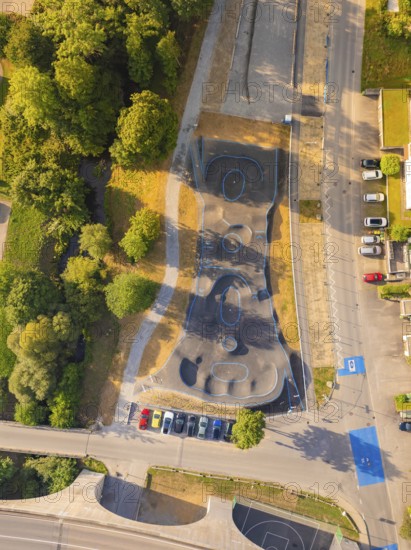 Top view of a tarmac pump track next to a road and trees, pump track, Nagold, Black Forest, Germany