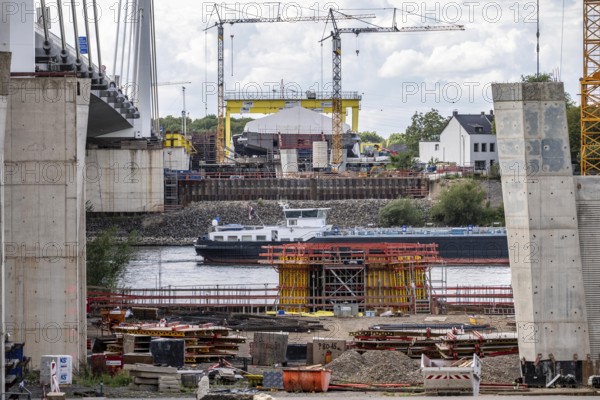 New construction of the second motorway bridge Neuenkamp of the A40, over the Rhine near Duisburg, parallel to the already existing first bridge, most of the new bridge piers are in place, two first bridge segments are finished and have already been moved towards the river on both sides of the Rhine, full completion is planned for 2028, North Rhine-Westphalia, Germany