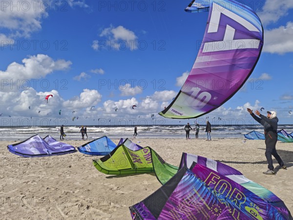 California kitesurfing Masters 2025, kite catching, kitesurfing on the North Sea beach on the edge of the UNESCO World Heritage Wadden Sea, sports competition, strong wind, high swell, whitecaps, summer, sun, blue sky, white clouds, Ording, Sankt Peter-Ording, Schleswig-Holstein, Germany