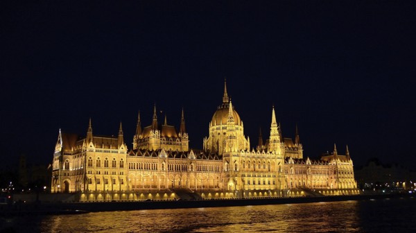 Golden lights highlighting the hungarian parliament building in budapest on the danube river at night