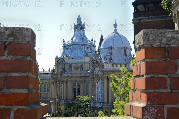 Architectural detail of vajdahunyad castle seen through brick battlements on a sunny day in budapest