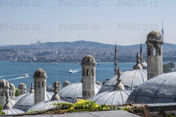 Traditional ottoman architecture dominates the foreground, with the bosphorus strait and the asian side of istanbul stretching out beyond